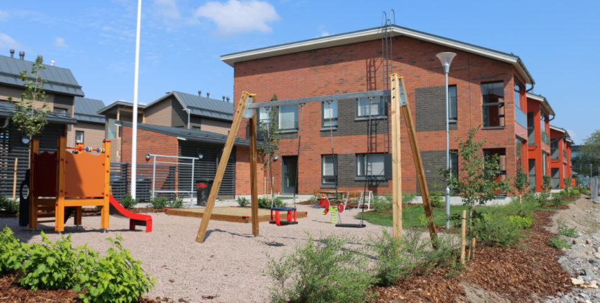 Kuunliljan vuokra-asuntojen pihalla on leikkipaikka, jossa on keinu, liukumäki sekä hiekkalaatikko. Alue rajautuu istutuksiin ja pieneen nurmikkoalueeseen.