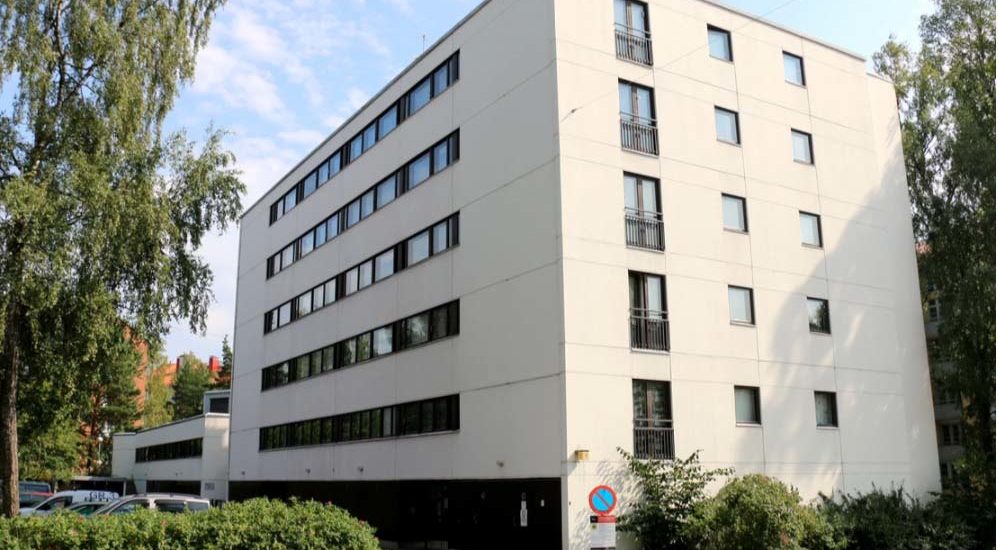 Asunto Oy Helsingin Meripuistotien julkisivu. Kerrostalo on valkoinen ja siinä on viisi kerrosta.